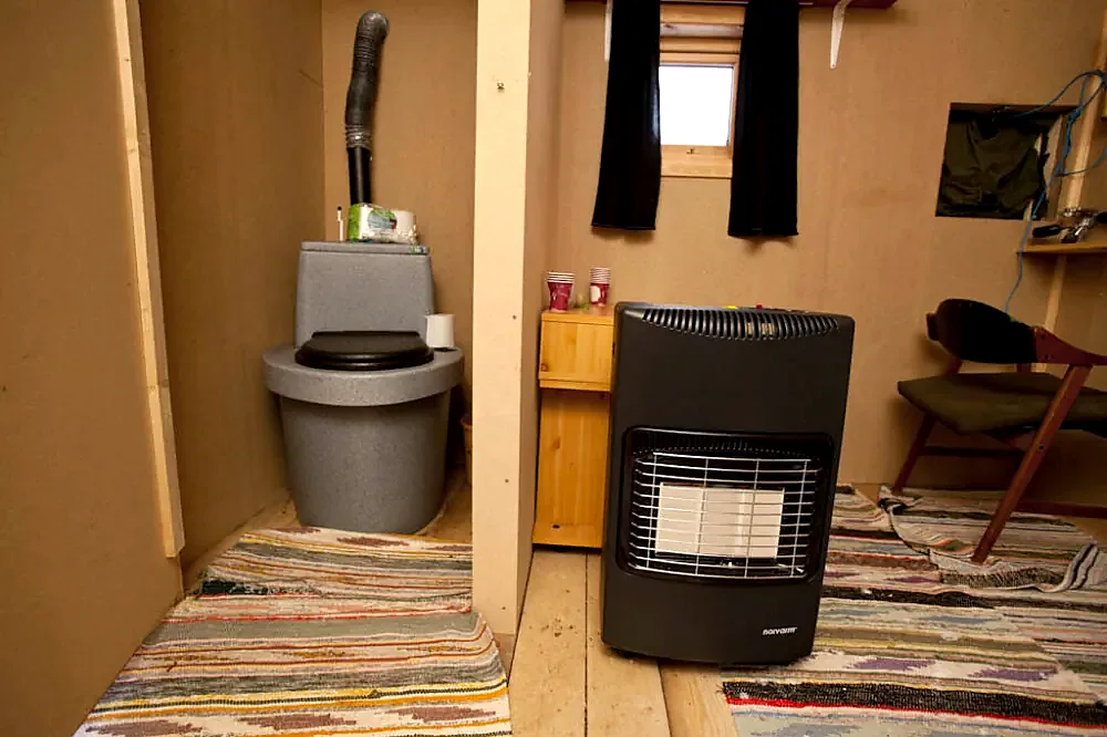 Dry toilet and heater inside the photography hide