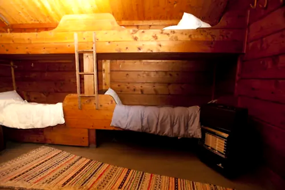 Simple sleeping area with beds inside the Red Cabin